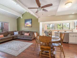 This stunning property boasts a spacious living area with a cozy sectional sofa and a beautiful rug, perfect for relaxing or entertaining.