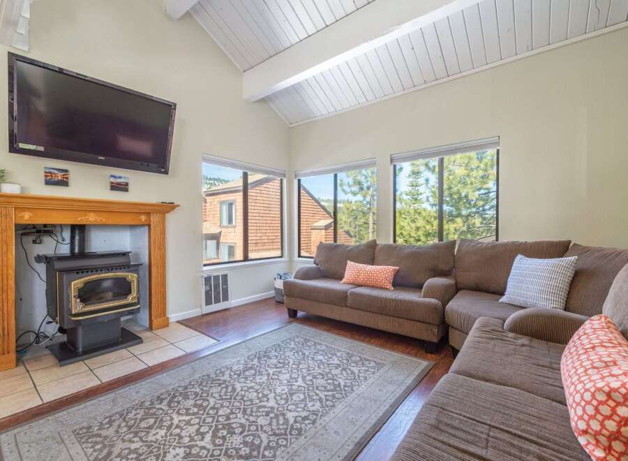 This cozy living room features a beautiful fireplace and a comfortable sectional sofa, perfect for relaxing.