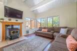 This cozy living room features a beautiful fireplace and a comfortable sectional sofa, perfect for relaxing.