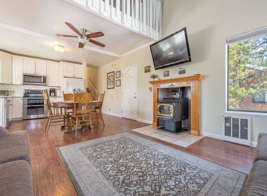 Step into this inviting living space, featuring a cozy fireplace and a large window that floods the room with natural light.