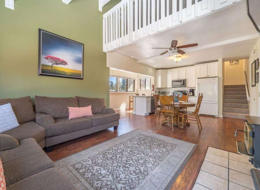 This stunning property boasts a spacious living area with a cozy fireplace, perfect for relaxing evenings.