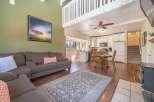 This stunning property boasts a spacious living area with a cozy fireplace, perfect for relaxing evenings.