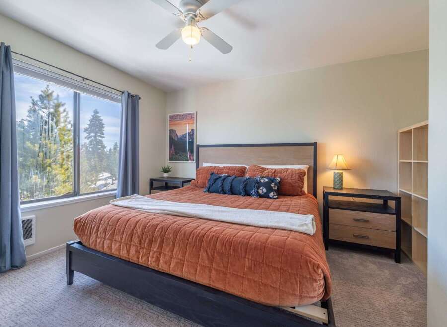 Step into this inviting bedroom, featuring a cozy bed adorned with plush bedding and decorative pillows.