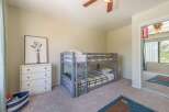 This charming bedroom features a cozy bunk bed, perfect for kids or guests.