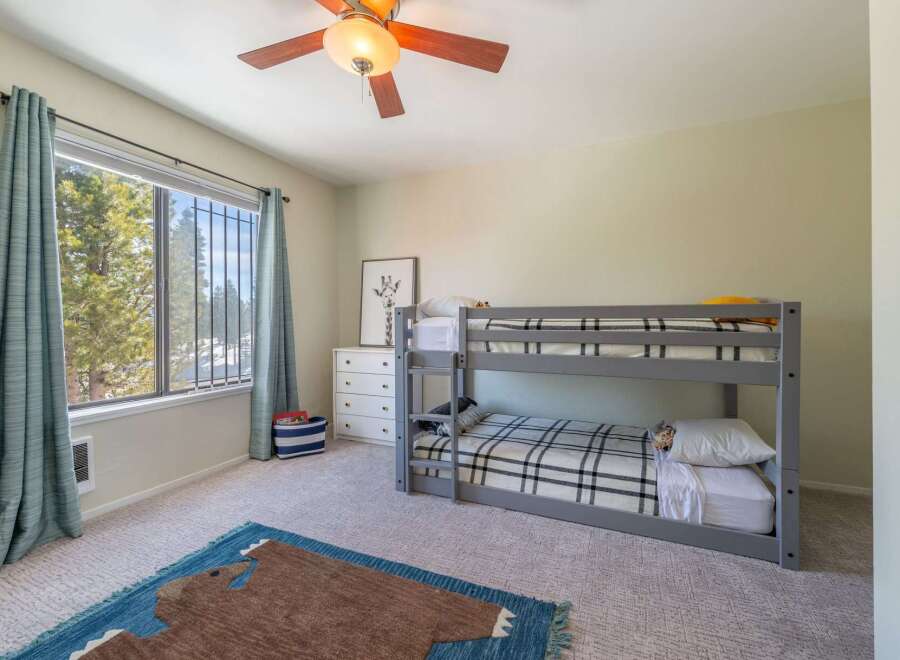 This charming bedroom features a cozy bunk bed, perfect for kids or guests.