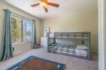 This charming bedroom features a cozy bunk bed, perfect for kids or guests.