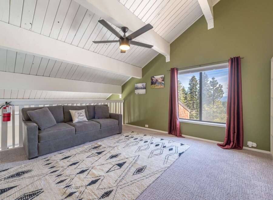Discover the charm of this inviting living space, featuring a cozy sofa and a stylish rug.