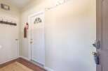 Step into this inviting entryway, featuring a bright white door with a stylish arched window.