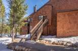 This charming property features a beautiful exterior with wooden shingles and a welcoming staircase.
