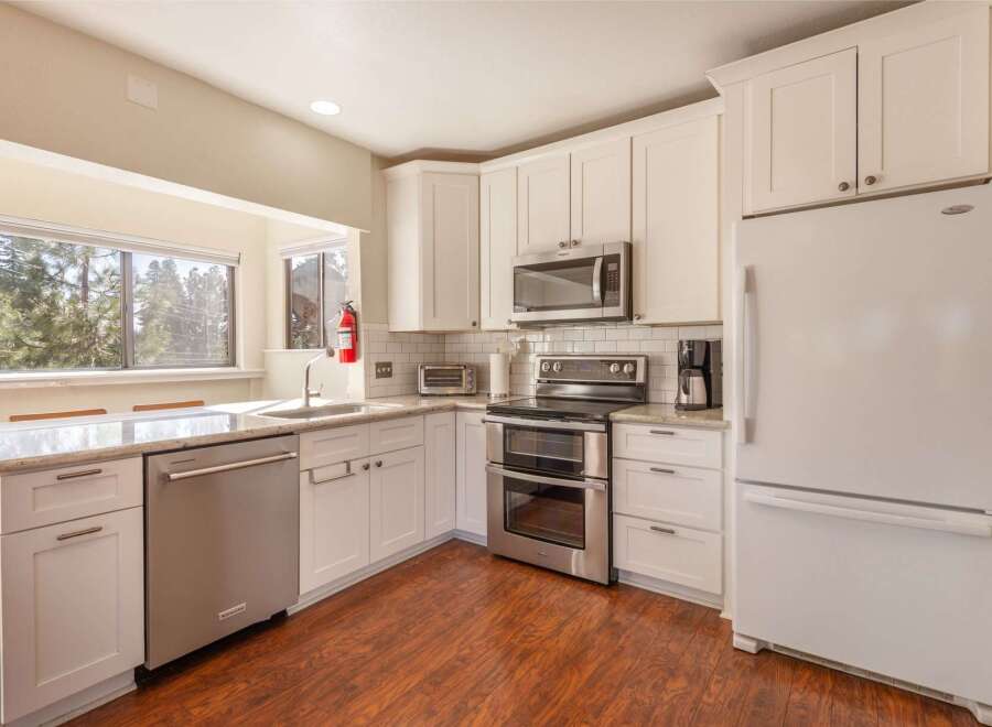 This bright and airy kitchen boasts modern appliances and ample counter space, perfect for culinary enthusiasts.