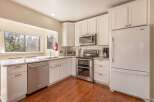 This bright and airy kitchen boasts modern appliances and ample counter space, perfect for culinary enthusiasts.
