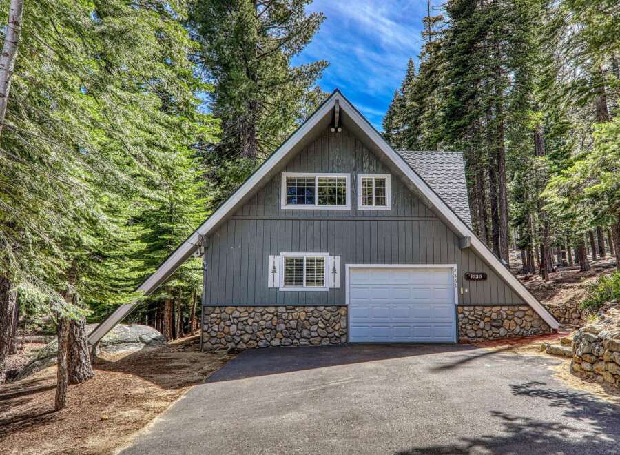 Nestled amidst towering trees, this charming A-frame cabin offers a serene escape.