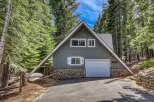 Nestled amidst towering trees, this charming A-frame cabin offers a serene escape.