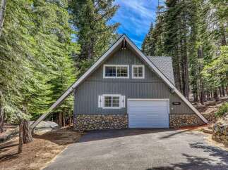 Nestled amidst towering trees, this charming A-frame cabin offers a serene escape.