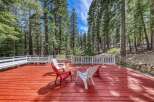Enjoy the tranquility of nature from this stunning deck surrounded by towering trees.