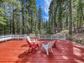 Enjoy the tranquility of nature from this stunning deck surrounded by towering trees.