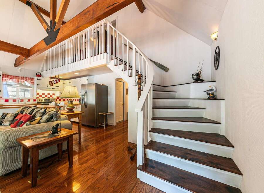 This charming home features a unique layout with a loft and a stunning staircase.