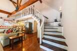 This charming home features a unique layout with a loft and a stunning staircase.