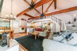 This charming property boasts a unique architectural design with exposed wooden beams and a loft area, creating a spacious and inviting atmosphere.