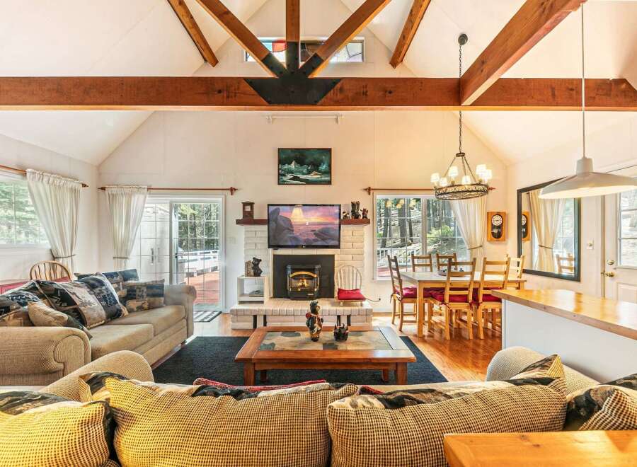Step into this inviting living space, featuring a cozy fireplace and a stylish dining area.