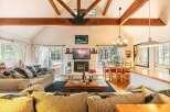 Step into this inviting living space, featuring a cozy fireplace and a stylish dining area.