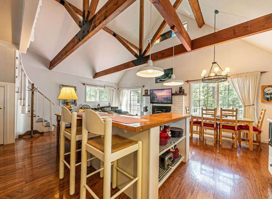 Step into this stunning property featuring a spacious kitchen with a large island and seating, perfect for entertaining.
