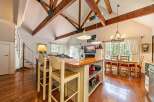 Step into this stunning property featuring a spacious kitchen with a large island and seating, perfect for entertaining.