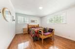 This inviting bedroom features a cozy bed with a vibrant quilt, creating a warm and welcoming atmosphere.