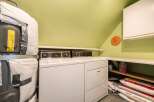 This laundry room offers a practical and functional space for your daily chores.