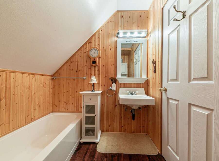 Step into a charming bathroom with rustic wood paneling that exudes warmth and character.