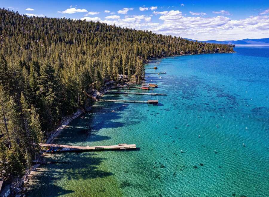 Discover your dream waterfront property! This stunning home boasts crystal-clear waters, private docks, and breathtaking views of the surrounding mountains.