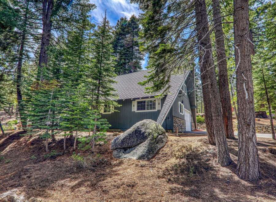 Nestled amidst towering trees, this charming A-frame cabin offers a serene escape.