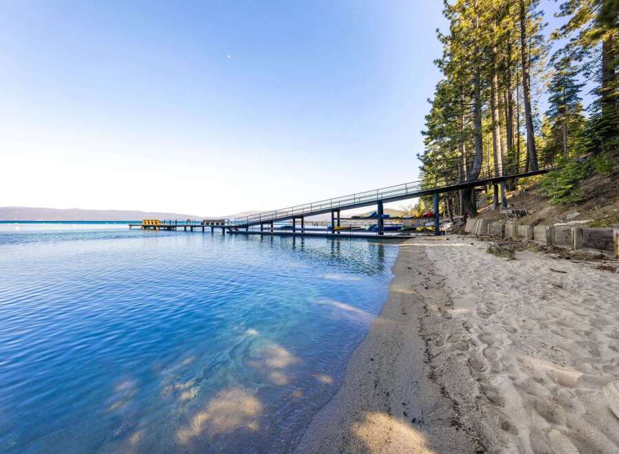 Discover waterfront living at its finest! This stunning property boasts a private beach and a unique pier, perfect for enjoying the crystal-clear waters.