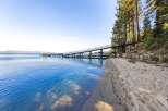 Discover waterfront living at its finest! This stunning property boasts a private beach and a unique pier, perfect for enjoying the crystal-clear waters.