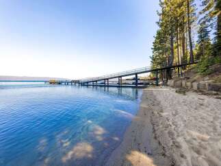 Discover waterfront living at its finest! This stunning property boasts a private beach and a unique pier, perfect for enjoying the crystal-clear waters.