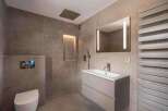 This modern bathroom features sleek design elements and high-end finishes.