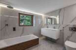 This stunning bathroom boasts a modern design with luxurious marble-effect tiles.