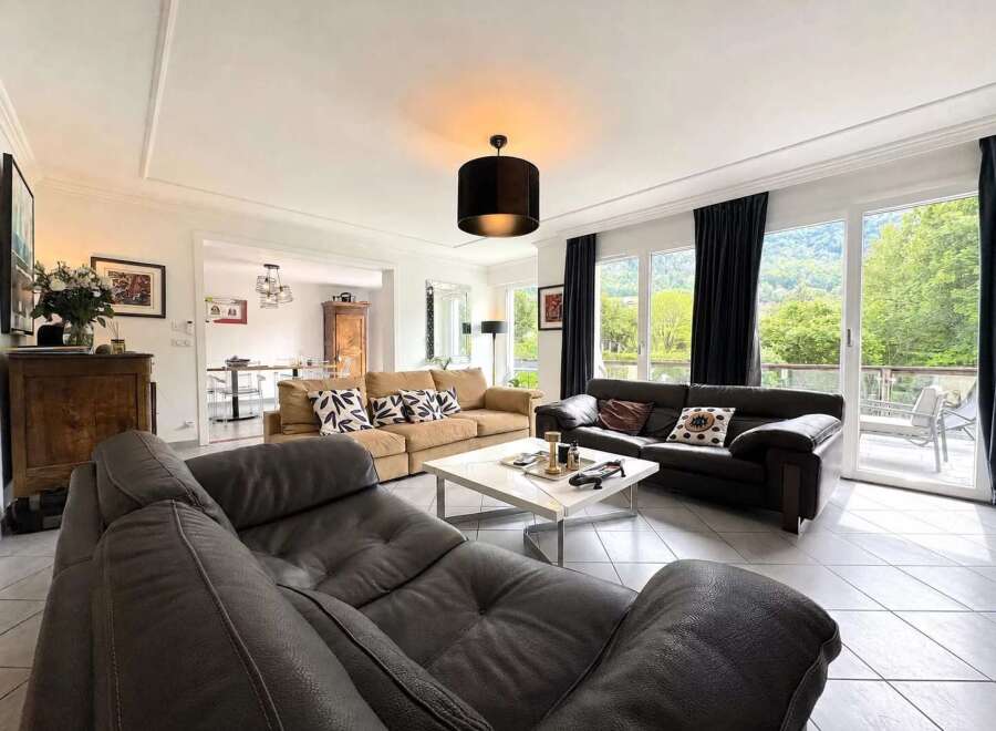 Experience luxurious living in this spacious living room, featuring comfortable seating arrangements and elegant decor.