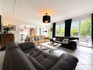 Experience luxurious living in this spacious living room, featuring comfortable seating arrangements and elegant decor.