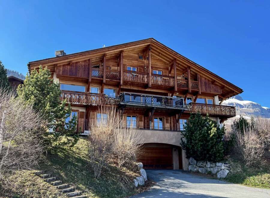 This stunning wooden chalet offers a luxurious mountain retreat with breathtaking views.