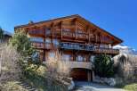 This stunning wooden chalet offers a luxurious mountain retreat with breathtaking views.