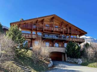 This stunning wooden chalet offers a luxurious mountain retreat with breathtaking views.