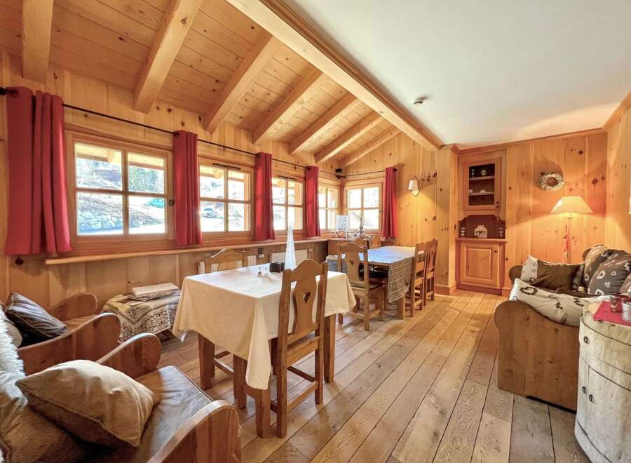 Step into this charming cabin retreat, featuring a warm and inviting interior with wooden walls and ceilings.