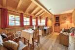 Step into this charming cabin retreat, featuring a warm and inviting interior with wooden walls and ceilings.