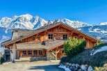 Nestled amidst the majestic snow-capped mountains, this stunning wooden chalet offers an idyllic retreat.