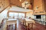 Step into a cozy and inviting restaurant with stunning mountain views.