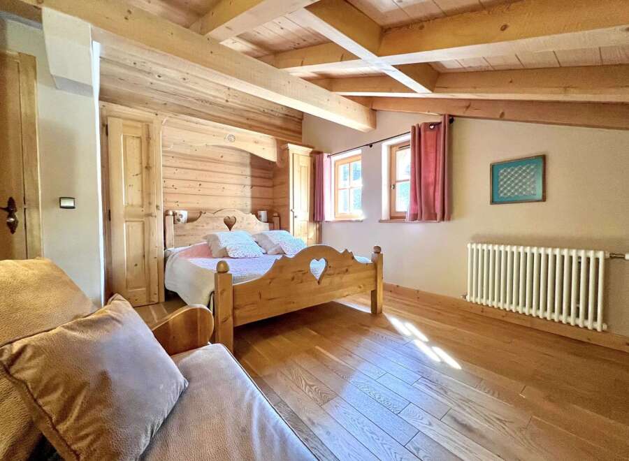 This charming bedroom boasts a rustic, wooden design with a cozy ambiance.