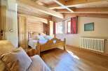 This charming bedroom boasts a rustic, wooden design with a cozy ambiance.