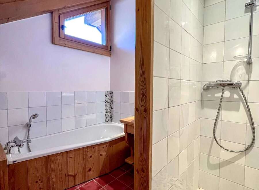 This charming bathroom features a unique design with a wooden ceiling and accents.