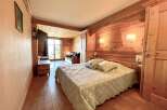This cozy bedroom features a warm wooden interior, creating a rustic and inviting atmosphere.